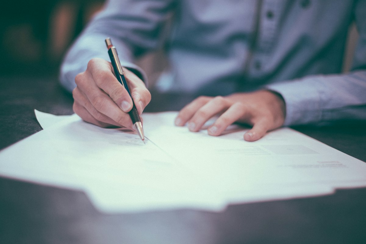 Tenant writing a formal demand letter at a desk